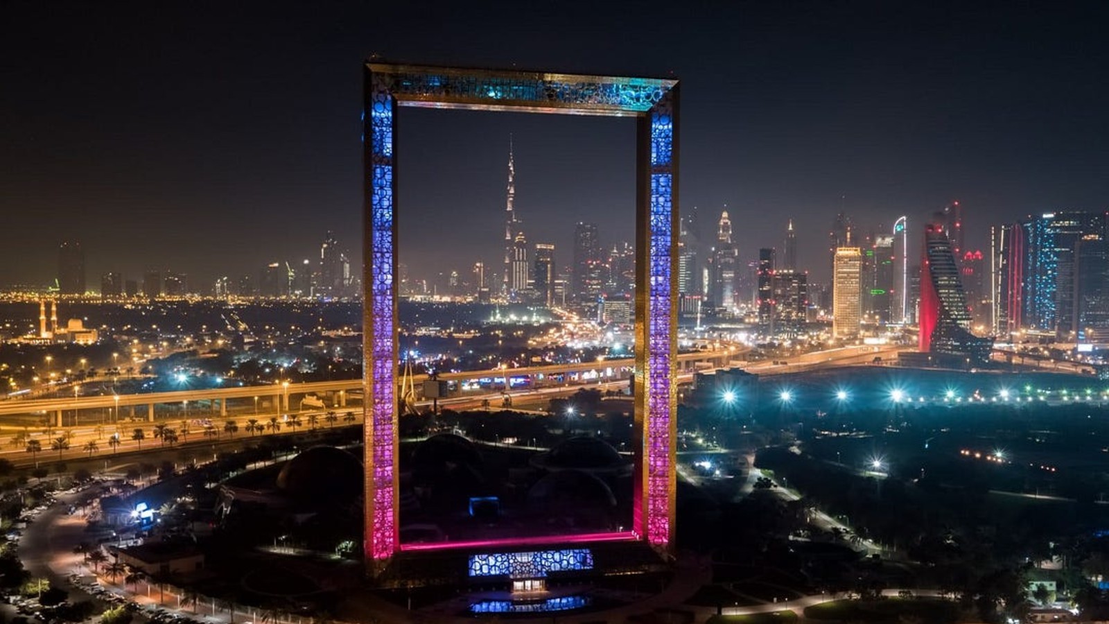 Vibrant Night Scene of Dubai Downtown with Illuminated Skyscrapers | Dubai Nightlife